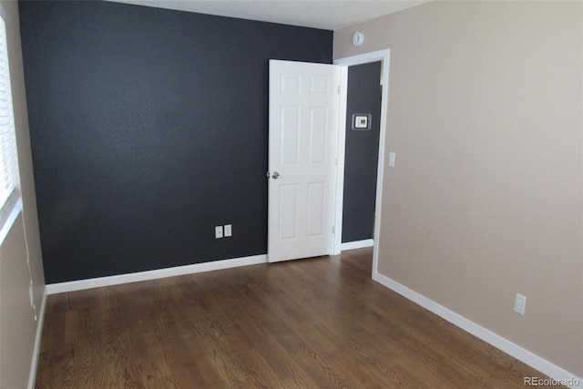 2517 S Genoa St, Aurora, CO 80013 - spare room with dark wood-type flooring, baseboards, and a smoke detector
