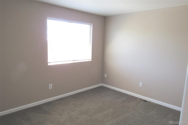 2517 S Genoa St, Aurora, CO 80013 - empty room featuring dark colored carpet and baseboards