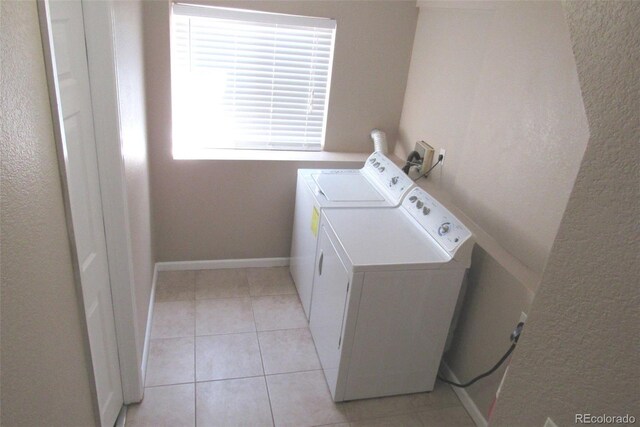 2517 S Genoa St, Aurora, CO 80013 - laundry room featuring washing machine and dryer, a textured wall, light tile patterned flooring, and baseboards