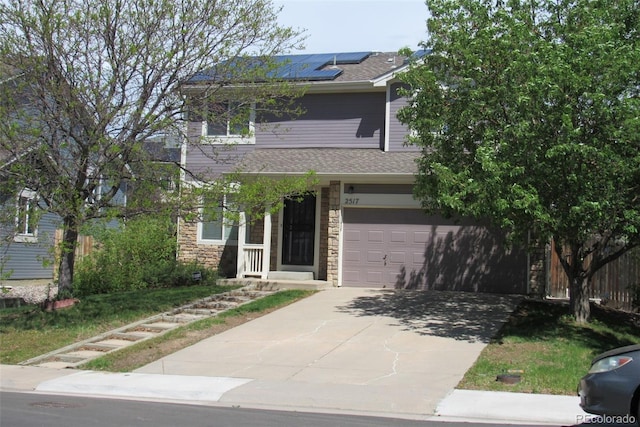 2517 S Genoa St, Aurora, CO 80013 - obstructed view of property featuring stone siding, solar panels, concrete driveway, a garage, and a shingled roof