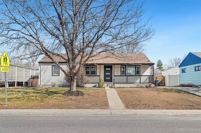 view of front of property with a porch and a front lawn