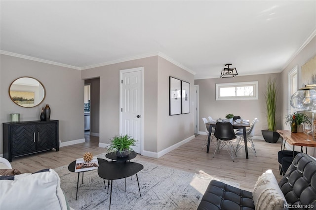 living area with crown molding, wood finished floors, and baseboards