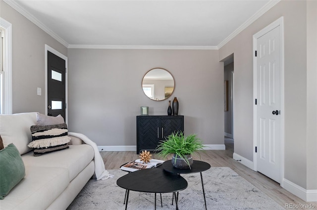 living area with ornamental molding, baseboards, and wood finished floors