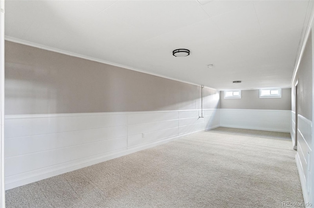 unfurnished room with wainscoting and carpet