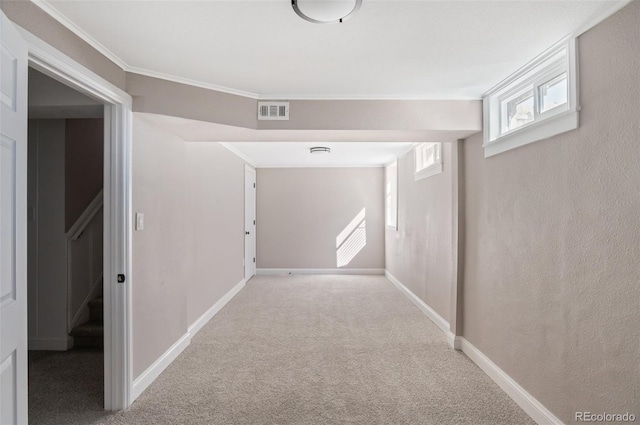 corridor with visible vents, crown molding, baseboards, stairway, and carpet flooring