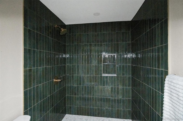 bathroom with a tile shower