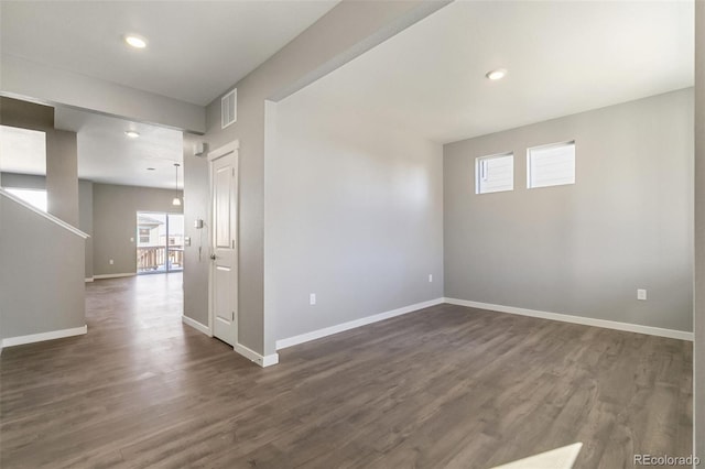27746 E Byers Pl, Aurora, CO 80018 - spare room featuring plenty of natural light, baseboards, dark wood finished floors, and recessed lighting