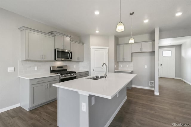 27746 E Byers Pl, Aurora, CO 80018 - kitchen with appliances with stainless steel finishes, a sink, gray cabinetry, decorative backsplash, and recessed lighting