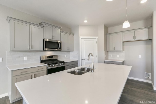 27746 E Byers Pl, Aurora, CO 80018 - kitchen featuring appliances with stainless steel finishes, gray cabinets, a sink, baseboards, and recessed lighting