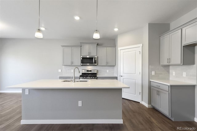 27746 E Byers Pl, Aurora, CO 80018 - kitchen with appliances with stainless steel finishes, gray cabinetry, a sink, backsplash, and recessed lighting