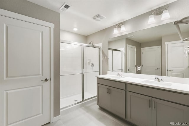 27746 E Byers Pl, Aurora, CO 80018 - full bath with a stall shower, tile patterned flooring, and double vanity