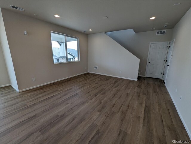 unfurnished living room with dark hardwood / wood-style flooring