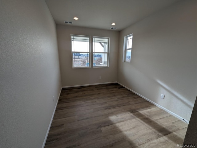 unfurnished room with hardwood / wood-style flooring