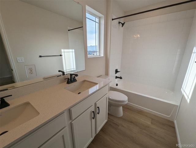 full bathroom featuring bathing tub / shower combination, vanity, wood-type flooring, and toilet