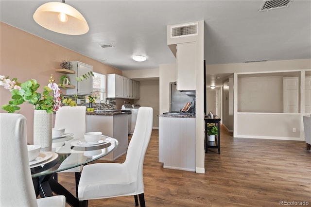 dining space with dark hardwood / wood-style flooring and sink