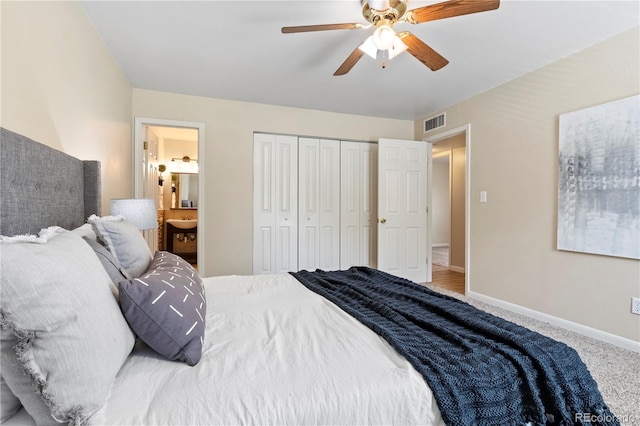 carpeted bedroom with ceiling fan, ensuite bathroom, and a closet