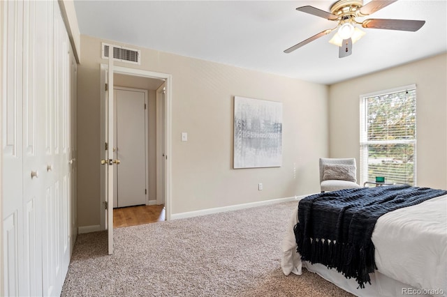 carpeted bedroom featuring a closet and ceiling fan