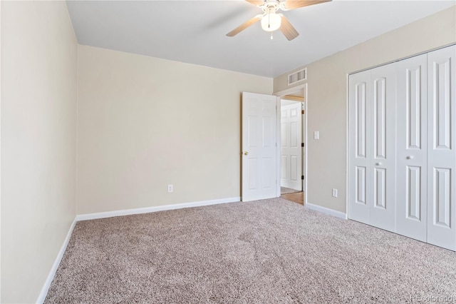 unfurnished bedroom with carpet, ceiling fan, and a closet