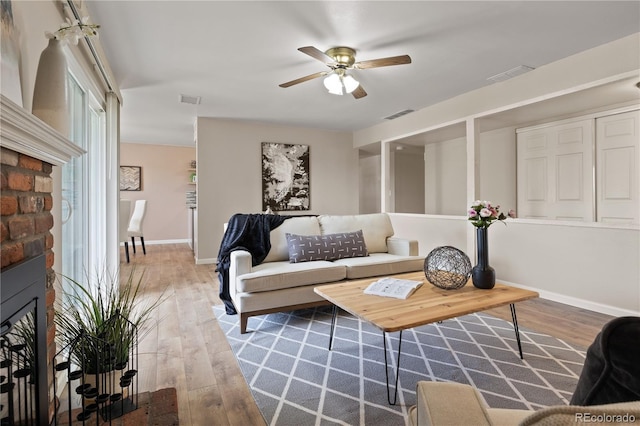 living room featuring wood-type flooring and ceiling fan