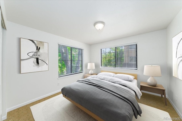 carpeted bedroom featuring baseboards