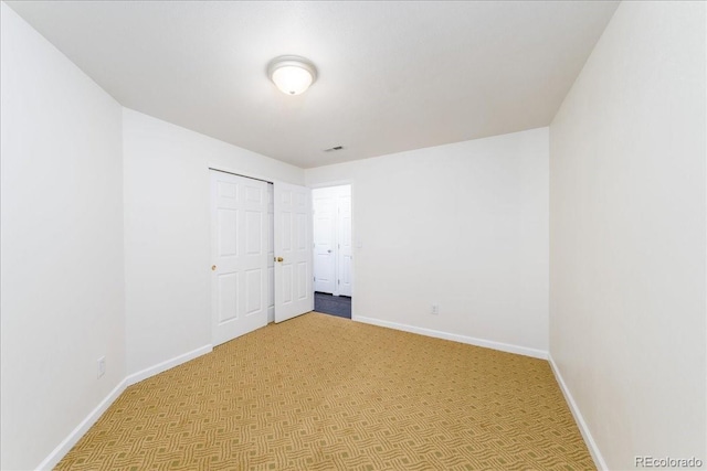 spare room with baseboards