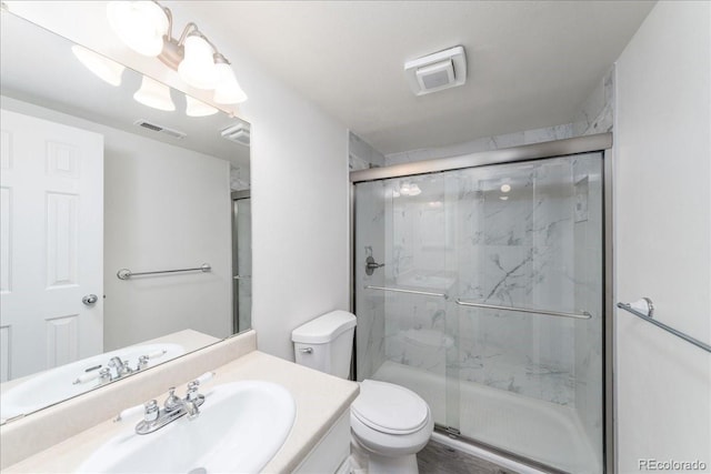 bathroom featuring a marble finish shower, visible vents, and toilet