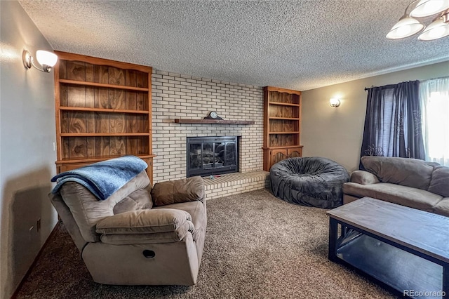 living area with built in shelves, carpet flooring, a textured ceiling, and a brick fireplace