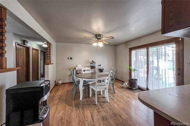 dining area with a ceiling fan and light wood-type flooring