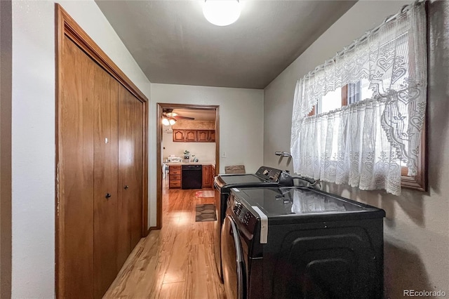 laundry area featuring independent washer and dryer, laundry area, and light wood-style flooring
