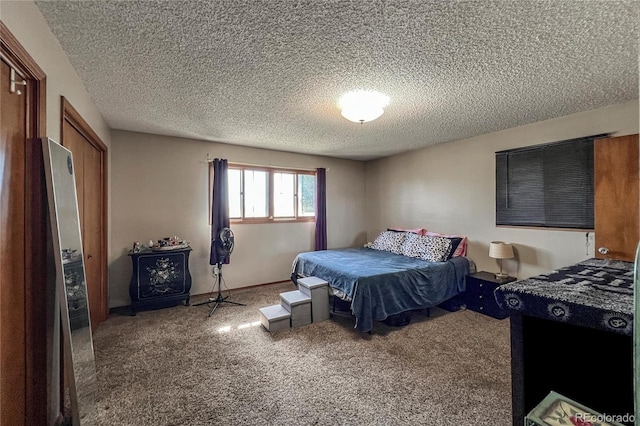bedroom with carpet floors and a textured ceiling