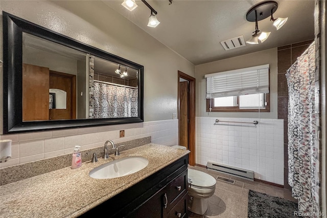 full bathroom with visible vents, tile walls, baseboard heating, vanity, and toilet