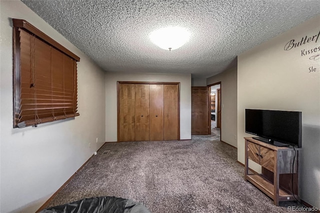 unfurnished bedroom with a closet, carpet flooring, and a textured ceiling