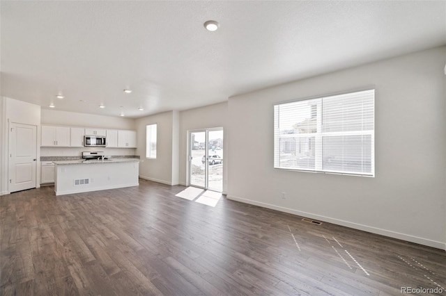 18126 Coppermallow Trl, Parker, CO 80134 - unfurnished living room with dark wood-type flooring and recessed lighting