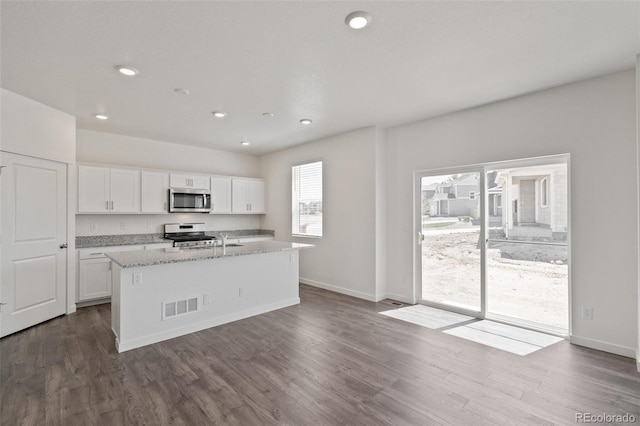 18126 Coppermallow Trl, Parker, CO 80134 - kitchen featuring stainless steel appliances, white cabinetry, dark wood-style floors, a kitchen island with sink, and recessed lighting