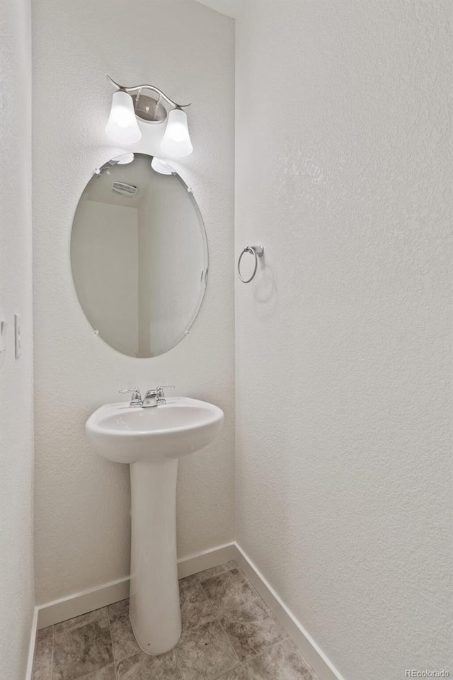 18126 Coppermallow Trl, Parker, CO 80134 - bathroom featuring a sink and baseboards
