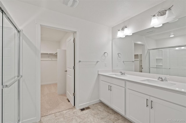 18126 Coppermallow Trl, Parker, CO 80134 - bathroom featuring a walk in closet, a stall shower, and double vanity