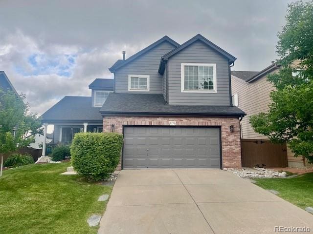 9758 Red Oakes Dr, Highlands Ranch, CO 80126 - view of front of house with brick siding, concrete driveway, an attached garage, and a front lawn