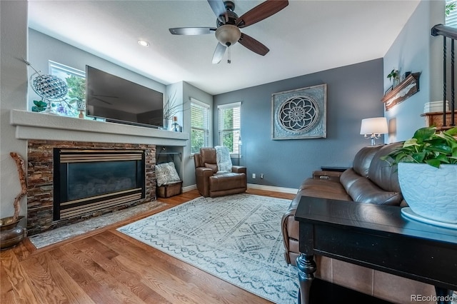 9758 Red Oakes Dr, Highlands Ranch, CO 80126 - living area featuring a fireplace, wood finished floors, and ceiling fan