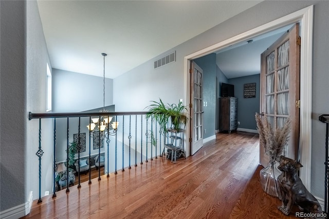 9758 Red Oakes Dr, Highlands Ranch, CO 80126 - corridor featuring a chandelier and wood finished floors