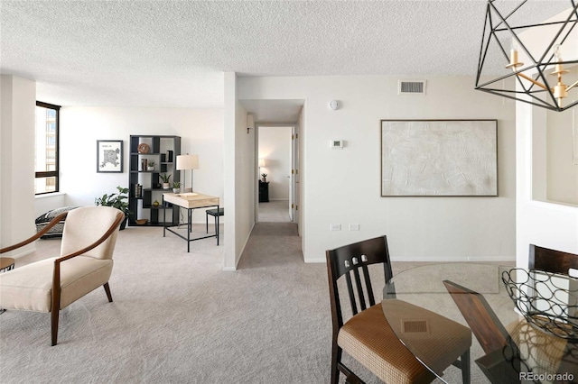 dining space with a notable chandelier, visible vents, light colored carpet, and a textured ceiling