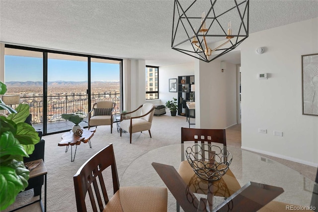 carpeted dining area featuring baseboards, an inviting chandelier, floor to ceiling windows, a textured ceiling, and a mountain view