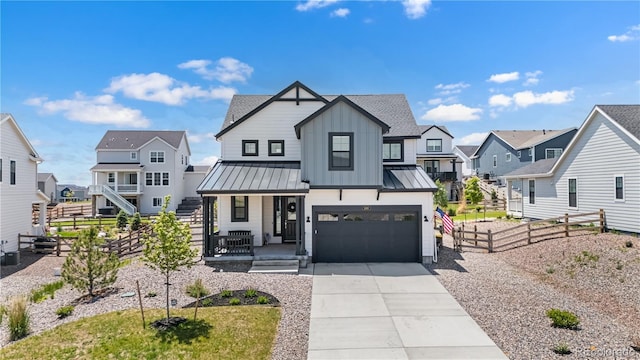 1168 Elbridge Dr, Elizabeth, CO 80107 - modern inspired farmhouse featuring a residential view, a porch, a standing seam roof, concrete driveway, and an attached garage
