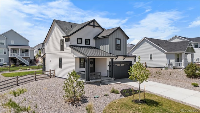 1168 Elbridge Dr, Elizabeth, CO 80107 - modern inspired farmhouse featuring a porch, driveway, a standing seam roof, a garage, and metal roof