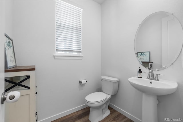 1168 Elbridge Dr, Elizabeth, CO 80107 - half bathroom featuring wood finished floors, toilet, and baseboards