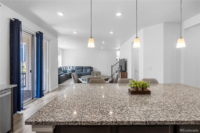 1168 Elbridge Dr, Elizabeth, CO 80107 - kitchen featuring light wood-type flooring, stone counters, recessed lighting, and hanging light fixtures