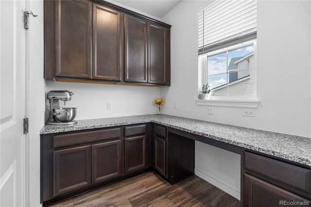 1168 Elbridge Dr, Elizabeth, CO 80107 - kitchen featuring dark brown cabinetry, dark wood-style floors, and light stone counters