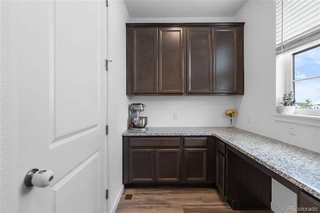 1168 Elbridge Dr, Elizabeth, CO 80107 - kitchen featuring dark brown cabinetry, light wood-type flooring, and light stone countertops