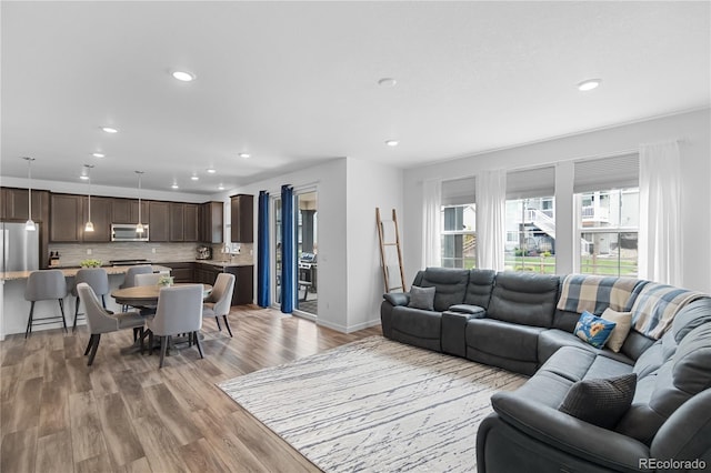 1168 Elbridge Dr, Elizabeth, CO 80107 - living area featuring light wood finished floors, recessed lighting, and baseboards