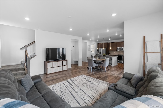 1168 Elbridge Dr, Elizabeth, CO 80107 - living area with recessed lighting, wood finished floors, stairway, and baseboards