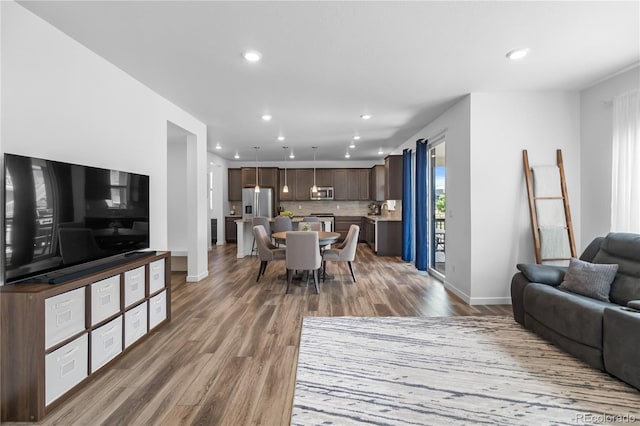 1168 Elbridge Dr, Elizabeth, CO 80107 - living area with wood finished floors, recessed lighting, and baseboards